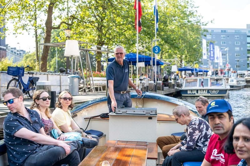 Amsterdam: 75 minute Open Boat Canal Cruise with Live Guide - Finding the Blue Boat dock near Hard Rock Cafe