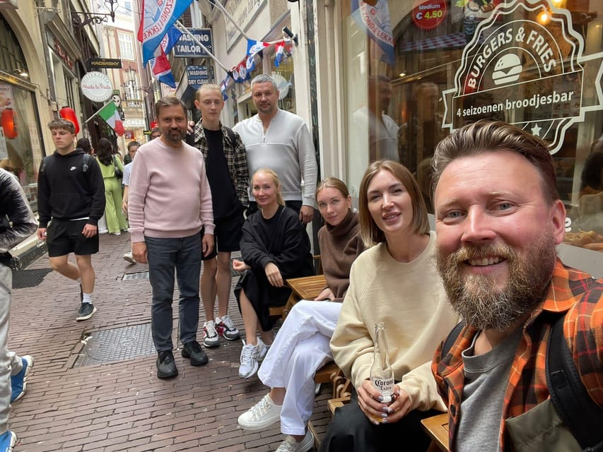 Amsterdam: City Highlights Walking Tour - Passing Damrak, Magna Plaza, and De Bijenkorf: you see the city you shop in