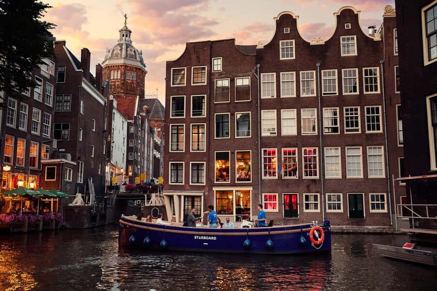 Amsterdam: Cozy Evening Canal Cruise With Open Bar Option - Meeting at Oudezijds Voorburgwal 230, then getting comfortable in rain or shine
