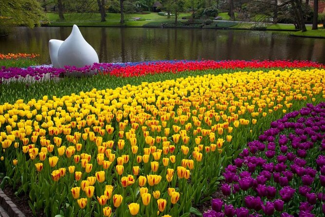Amsterdam: Day trip to Tulip Farm, Keukenhof + Windmill Cruise - Kagerplassen cruise: classic windmills, calm timing, and light commentary