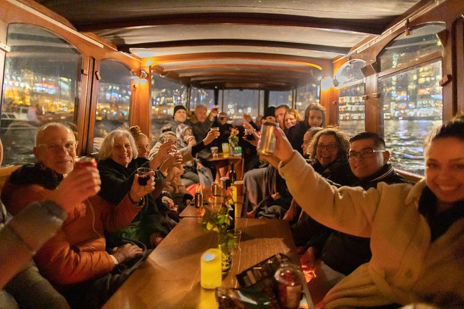 Amsterdam Evening Canal Cruise with Live Guide and Onboard Bar - Skinny Bridge (Magere Brug), Munttoren, and the Bridge Drama