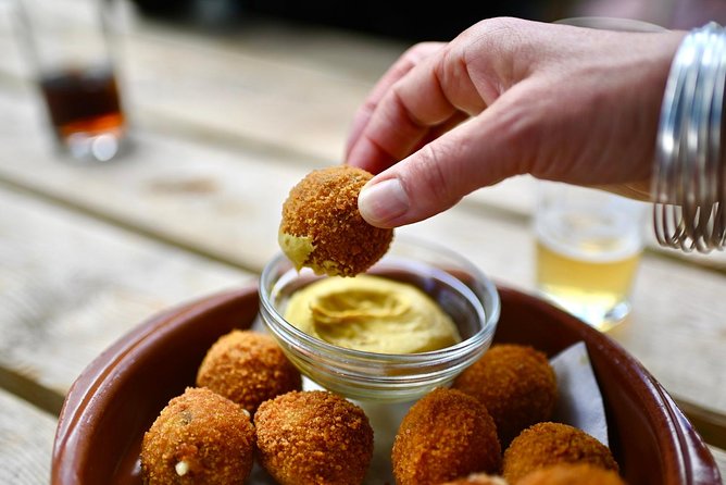Amsterdam Food Tour of 10+ Local Classic Tastings in Jordaan Area - The fishmonger stop: fresh herring and kibbeling
