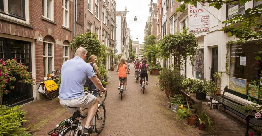 Amsterdam: Hidden Gems & Highlights Guided Bike Tour - Jordaan: backstreets, courtyards, and churches that tourists often miss