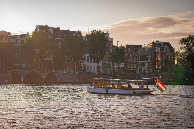 Amsterdam Highlights Canal Cruise with a Drink - Classic wooden boat comfort, wine included, and the 90-minute rhythm