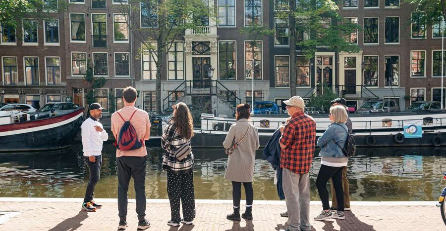 Amsterdam: Highlights & History Walking Tour - Old Town streets, historic corners, and the stories behind the odd shapes