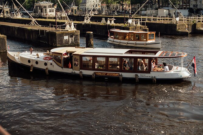 Amsterdam: Luxury Saloon Boat Cruise with Cocktails & Waffle - Getting on at the NH Krasnapolsky dock, without wasting time