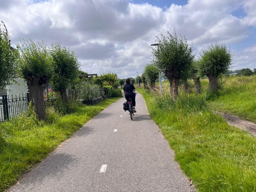 Amsterdam: Rainbow Rural Bike Tour With Local Gay Guide - Ferry ride back, skyline views without the tourist squeeze