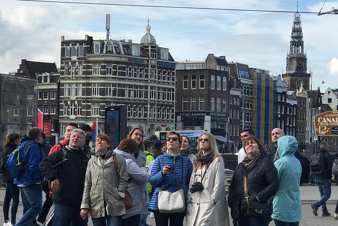 Amsterdam Sightseeing Tour + Hidden Gems + Tastings + PDF guide - Pathe Tuschinski and the Bloemenmarkt float: architecture fans will be happy