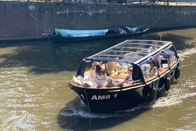 Amsterdam Small-Group Canal Cruise Including Snacks and Drinks - Cruising via the Amstel toward the Red Light District