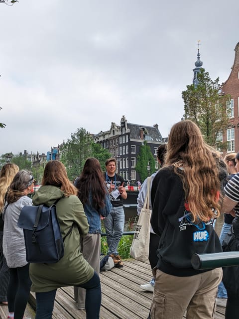 Amsterdam: small group tour: History, humor & hidden gems - Meeting at Those Dam Boat Guys, then setting off along the canal belt