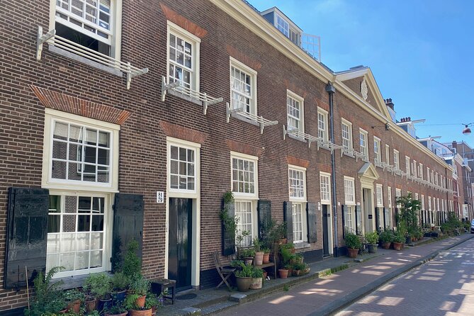 Explore hidden streets with friends - Private Tour - Amsterdams Quiet Side Starts at Beursplein