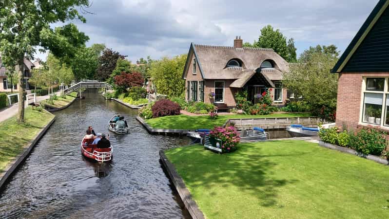 From Amsterdam: Giethoorn Small Group Tour with Boat Ride - The Amsterdam Central meet-up and the comfortable van ride