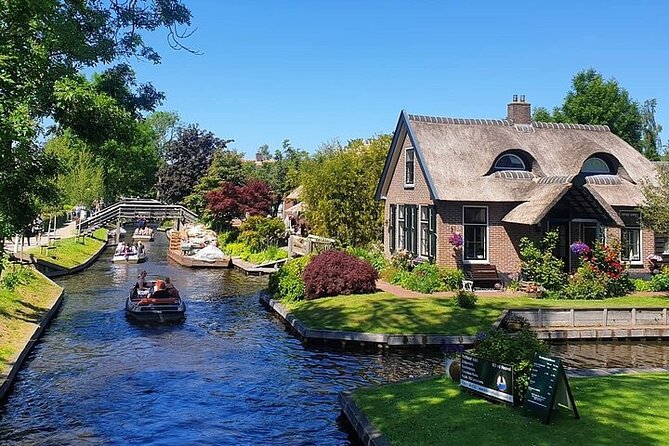 Giethoorn Day Tour from Amsterdam with Small Boat Ride - The Electric Boat Hour: Bridges, Hand-On Time, and Real Canal Scale