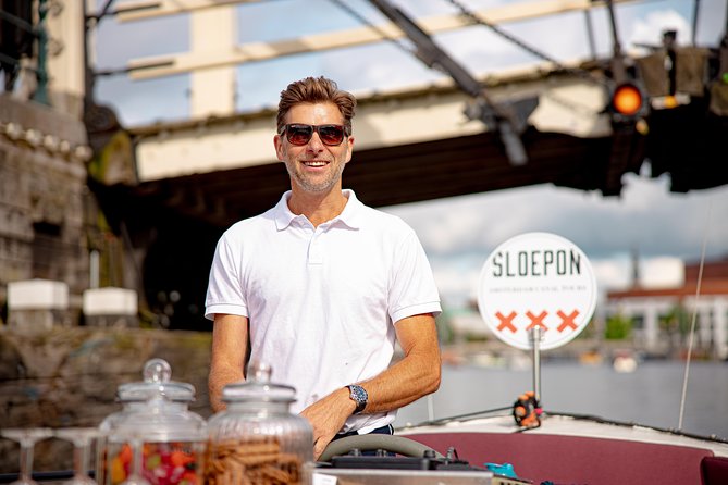Guided Amsterdam Canal Cruise – Snacks & Drinks on board(1 Hour) - Stop-by-stop: Red Light District landmarks to the maritime “start” of Amsterdam