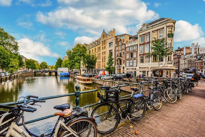 Private Tour: Amsterdam City Walking Tour and Canal Cruise - Dam Square sights, war memorial context, and what to notice on your photos